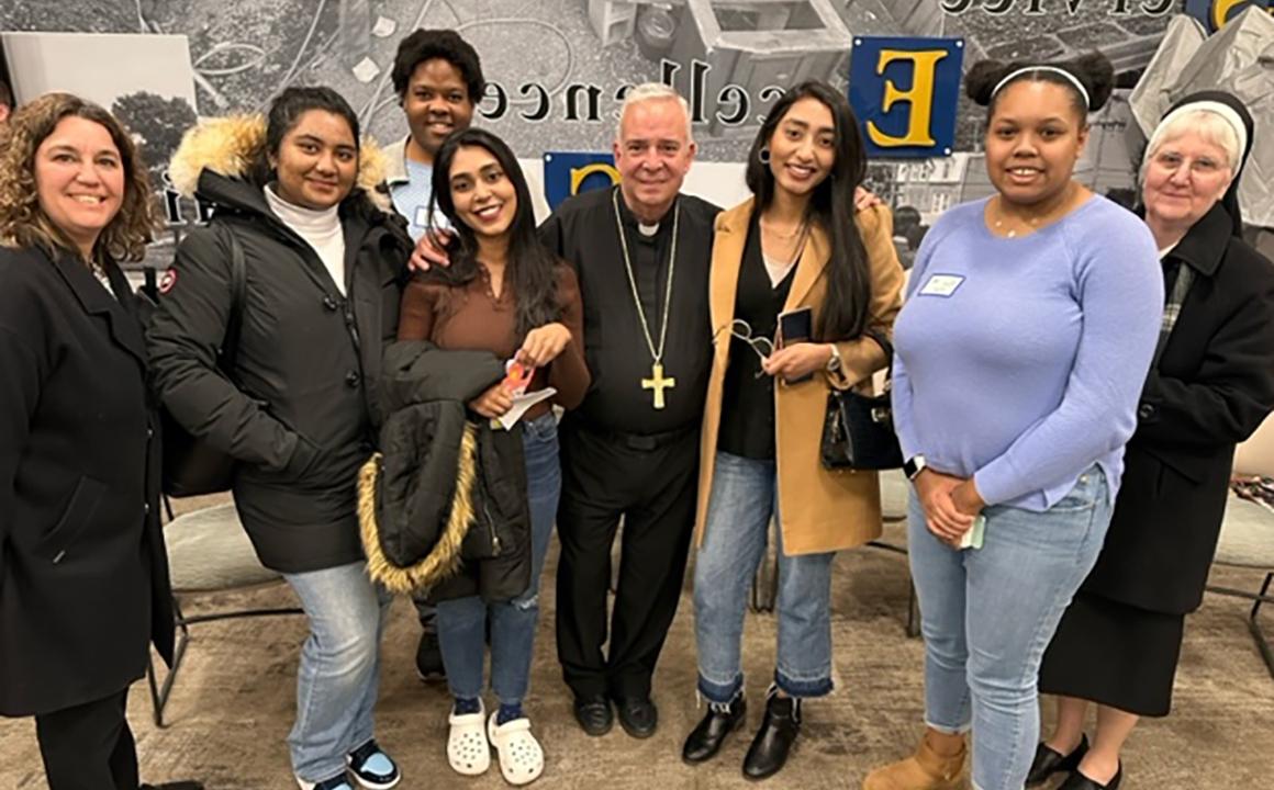 Sister Rita Fanning, CSFN, '89, vice president of Mission Integration (far left), Archbishop Nelson J. Pérez (center), and Jill Snyder, director of Campus Ministry (far right), with Holy Family University students Maya Myers, Kawish Sadaqat, Mehwish Sadaqat, Julian Stewart, and Esha Dean at the Synod on Synodality.